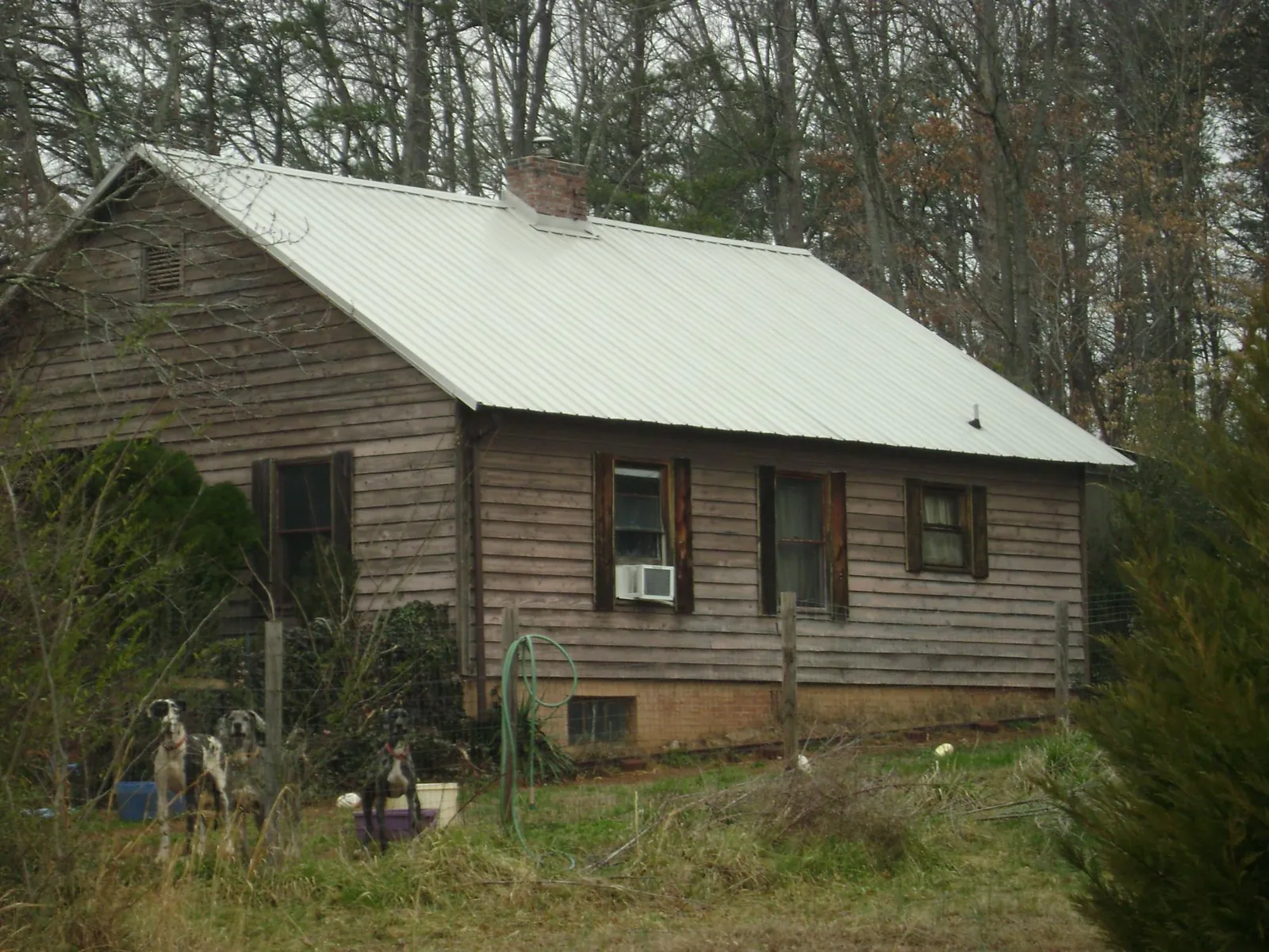 White metal roof on an old wood sided farmhouse, from a Metal Roof Installation job in Hortonville